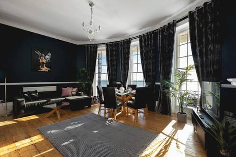 Elegant seafront apartment with stunning bay windows, rich velvet curtains, chic décor, and a bright open-plan lounge. Perfect for relaxing in style in Brighton