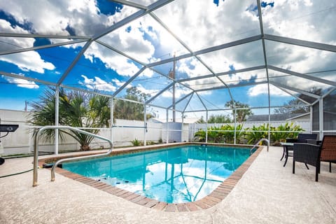 private screened pool and lanai at Englewood Florida vacation rental with outdoor seating area