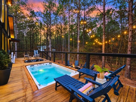 Unwind in the swim spa under string lights, surrounded by peaceful forest views. Swim spa can be heated in the cooler season (for free!)