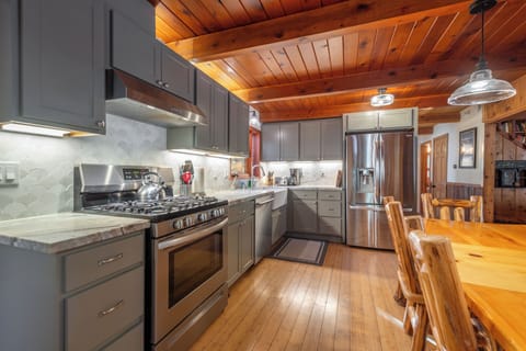 Remodeled kitchen with marble counters and stainless steel appliances