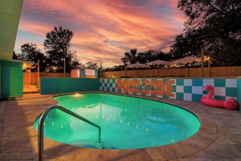 Sunset-lit backyard pool framed by desert landscaping, perfect for evening swims.