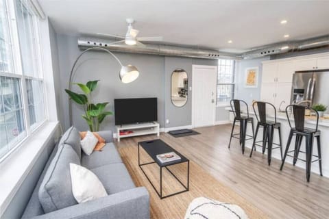 The living room is filled with natural light, creating a bright and welcoming space that invites relaxation.