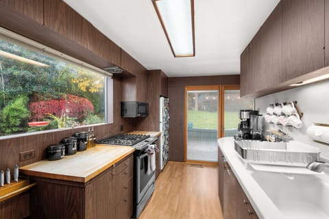 Fully equipped kitchen with a garden view.