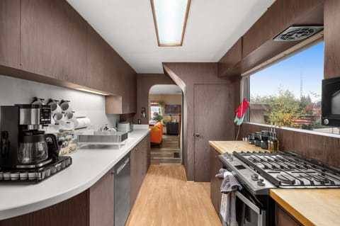 Fully equipped kitchen with a garden view.