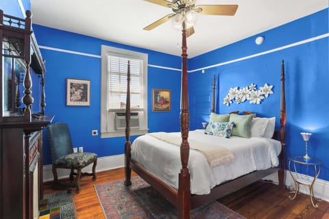 Bedroom featuring a comfortable queen bed, laundry, TV, sound machine, and AC/heat.
