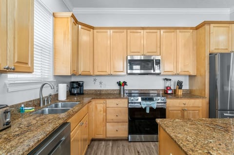 The open kitchen offers ample space & all the comforts of home
