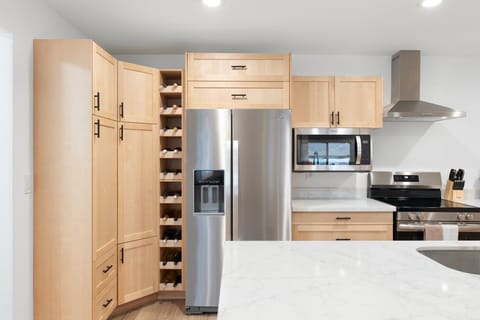 Features a large fridge and plenty of cabinetry, making meal prep a breeze.