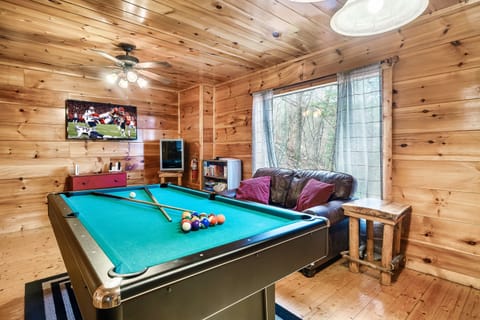 Unwind and have fun in the spacious game room featuring a classic billiard table