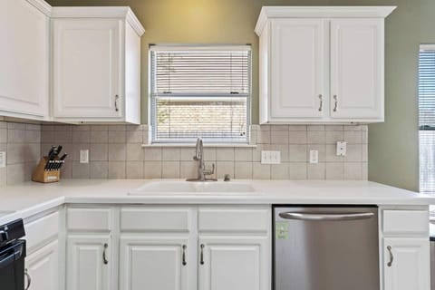Bright kitchen sink area with clean finishes and natural light