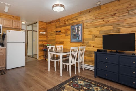 Cozy wood-paneled space where you'll enjoy meals around your private dining table while watching your favorite shows.