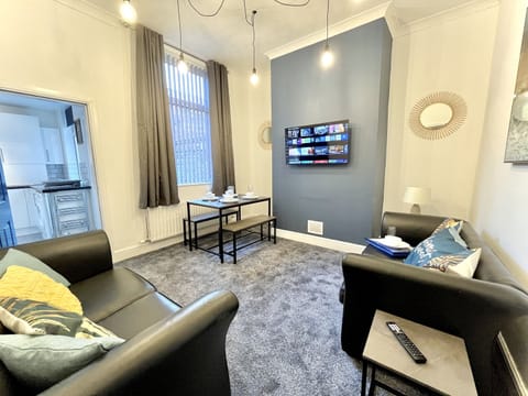 Living room with Smart TV and dining area