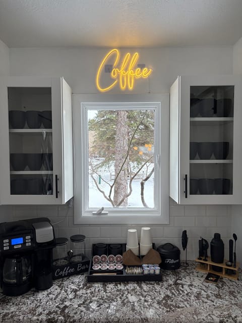 Coffee bar with drip maker, Keurig, creamer, sugar, to-go cups, mugs, and more.