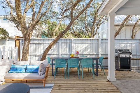Backyard features a grill, utensils and dining table.