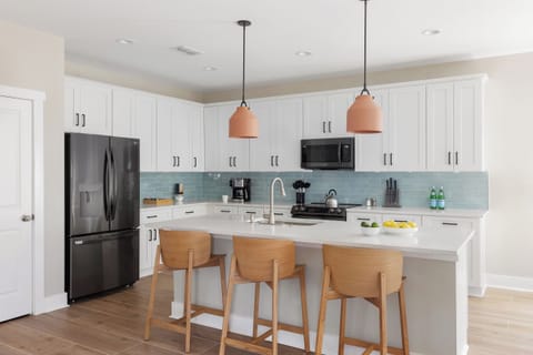 Fully equipped kitchen with stools for added convenience.