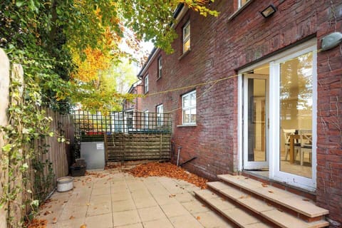 Rear patio of house with double door access from kitchen / dining room