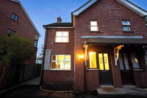 Front of house with designated parking spot on the left hand side of this photo