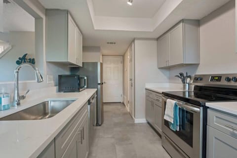Kitchen with entry to garage for laundry washer and dryer