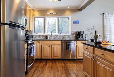 "Bright kitchen with stainless steel appliances."