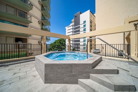 Relax in the soothing outdoor shared hot tub, the perfect spot to unwind after a day of island adventures.