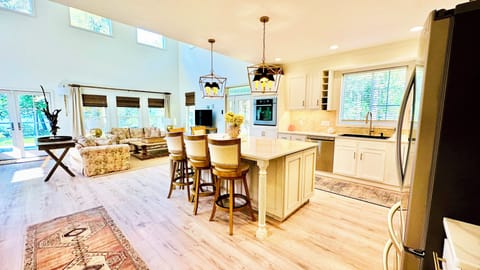 Open concept kitchen, family, and dining room with 18 ft lofted ceilings