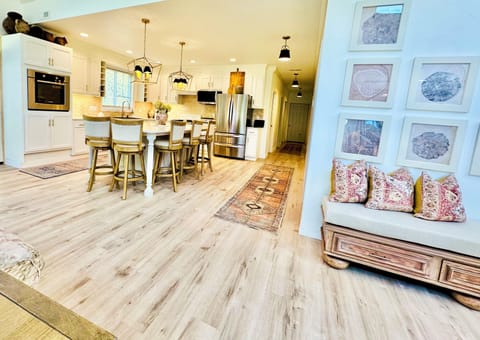 Open concept kitchen, family, and dining room with 18 ft lofted ceilings