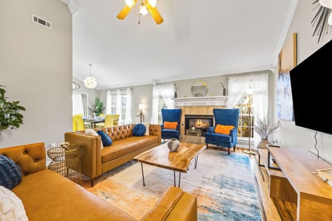 This large living room full of natural light has genuine leather couches.