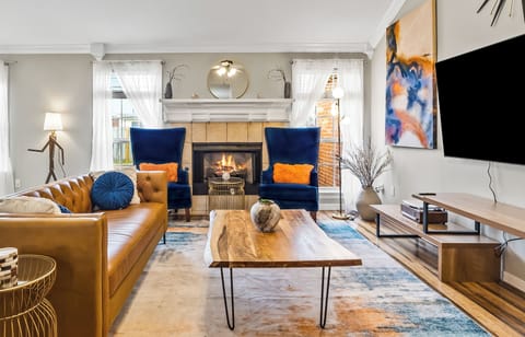 Genuine leather couches, cozy fireplace, and a 70" Samsung smart TV.