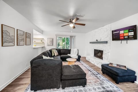 Cozy living room with comfortable seating and a modern TV setup.