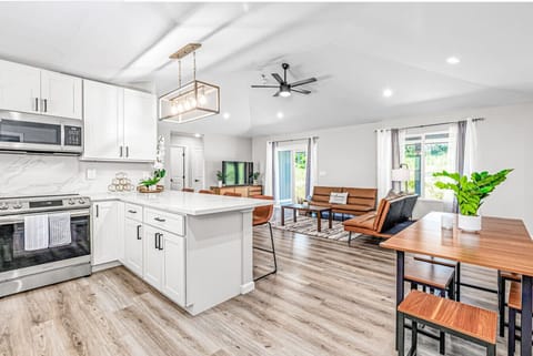 Modern kitchen with a dining space and natural light.