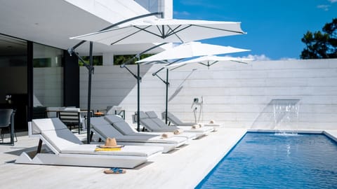 Patio with private heated pool, sun loungers and outside seating area in luxury private villa Calmissima 2 Starigrad 