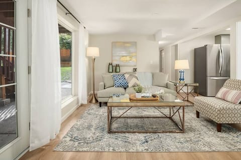 Lower level living/family room, perfect for entertaining and gathering. Slide door open to full fenced backyard. With a wet bar.