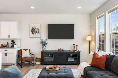 Unwind in the cozy living room featuring a large smart TV, perfect for movie nights, and stylish décor to complement the modern vibe.