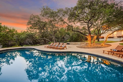 Enjoy the calm of this wooded oasis, where a sparkling pool and soft lighting create a resort-like vibe right in nature’s embrace.