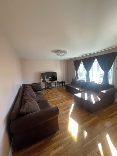 Living room with 60” tv, and bay windows