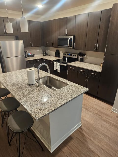 Stylish kitchen featuring premium finishes, spacious granite countertops, and full-size stainless steel appliances — ideal for extended stays.