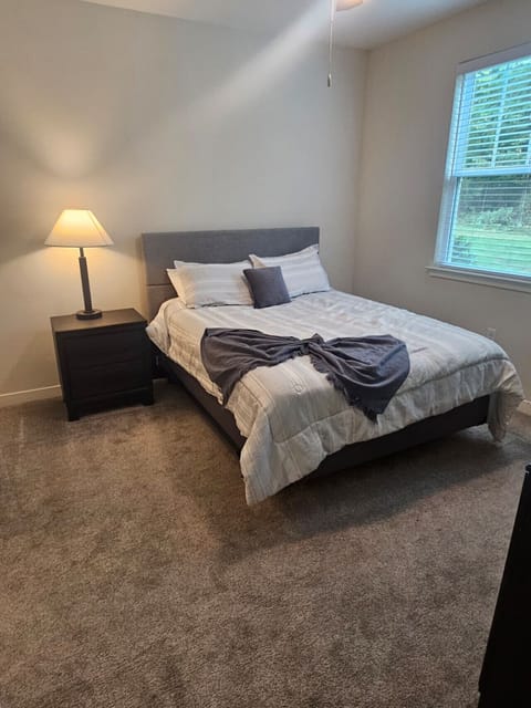 Inviting bedroom featuring a comfortable bed, soft lighting, and a serene view of the outdoors.