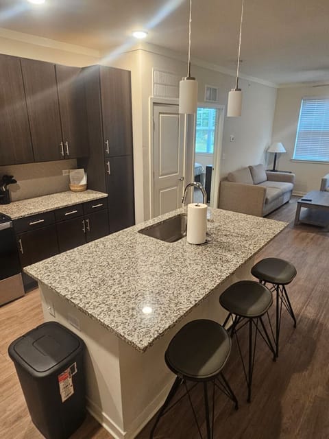 Stylish kitchen featuring premium finishes, spacious granite countertops, and full-size stainless steel appliances — ideal for extended stays.