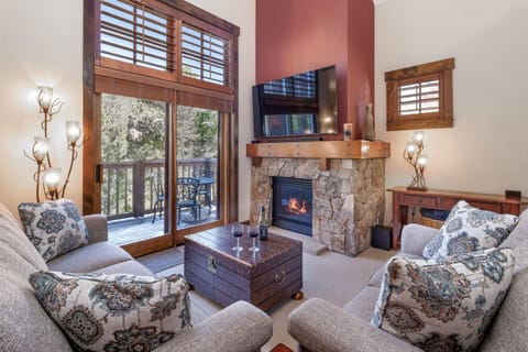 Living Room with Balcony and Vaulted Ceiling