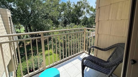 Accessible from the living area, the balcony includes a comfortable wicker armchair.