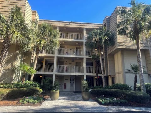 The condo is located in a well-maintained complex with a Mediterranean-style facade.