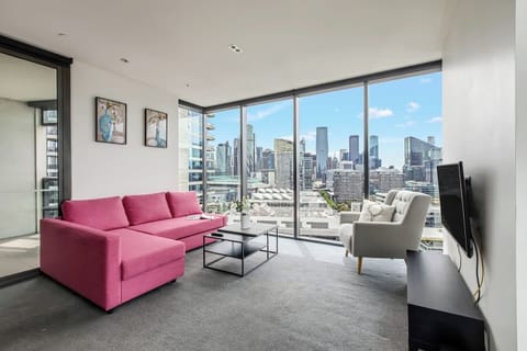 The living area offers a comfortable retreat with modern furnishings and breathtaking city views.