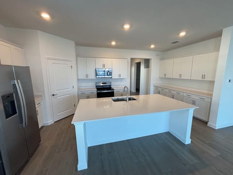 The kitchen is stocked with dishes, utensils, cookware, kitchen knives, & keurig