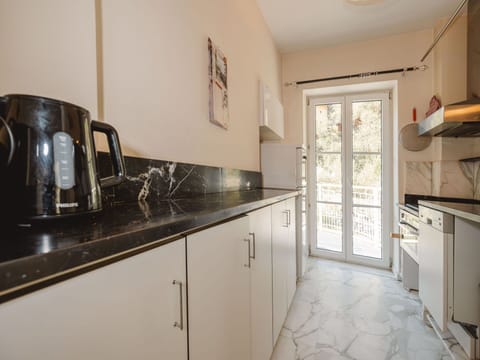 Flooring, Floor, Countertop, Interior Design, Kitchen, Kitchen Appliance, Cabinetry, Home Appliance, Tile