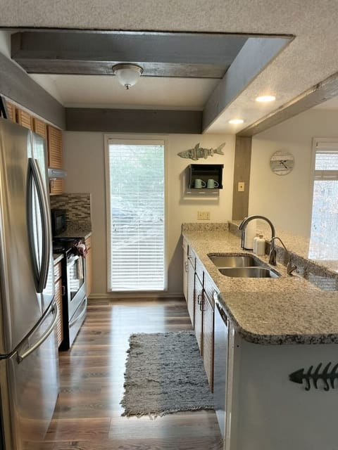Bright and spacious kitchen with granite counters, stainless steel appliances, and everything you need to prepare meals.