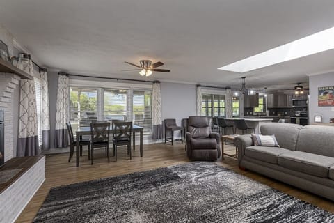 A cozy living room with a comfortable couch, a coffee table, and a warm fireplace.