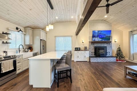 Open floor plan with high ceilings and a ceiling fan