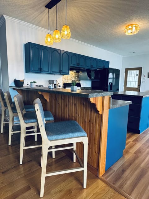 Newly painted kitchen cabinets with fully stocked kitchen