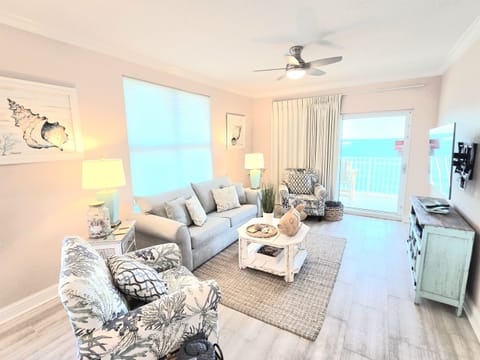 Living room with mounted flat screen and balcony access