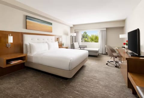 Unwind in a bright, airy room with plush bedding.