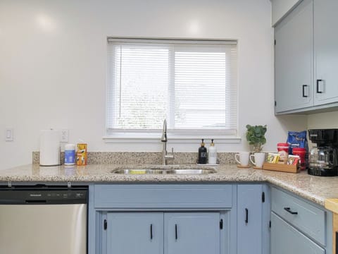 Clean and inviting kitchen with light blue cabinets.
